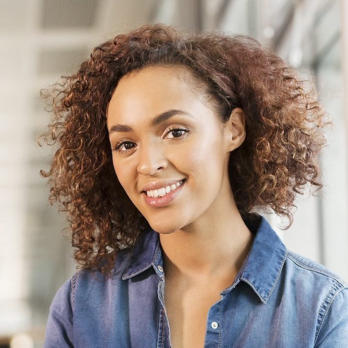 Portrait of female digital designer on office desk